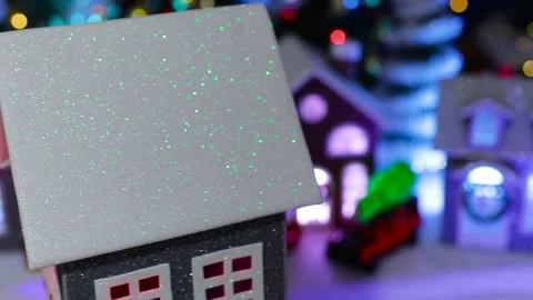 A grey house rotating in front of a Christmas village with a large tree Stock Footage 319895666