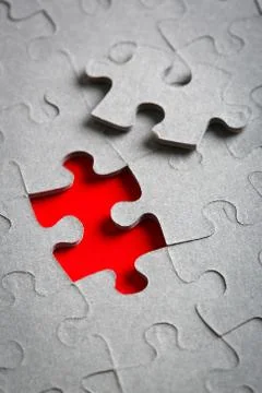Grey jigsaw puzzle texture with missing pieces Stock Photos