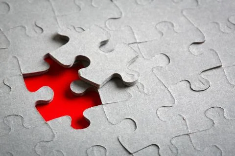 Grey jigsaw puzzle texture with missing pieces Stock Photos