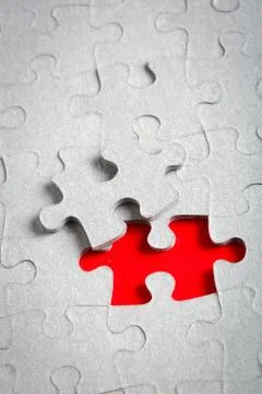 Grey jigsaw puzzle texture with missing pieces Stock Photos