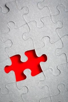 Grey jigsaw puzzle texture with missing pieces Stock Photos