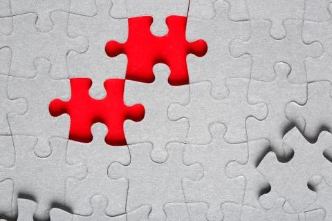 Grey jigsaw puzzle texture with missing pieces Stock Photos