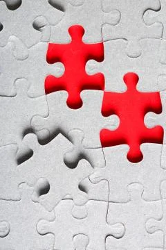 Grey jigsaw puzzle texture with missing pieces Stock Photos