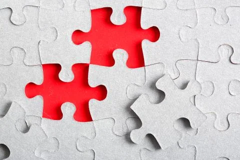 Grey jigsaw puzzle texture with missing pieces Stock Photos