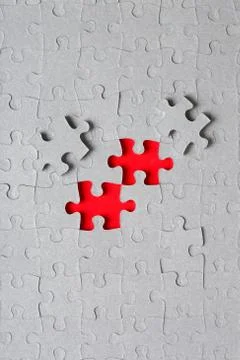 Grey jigsaw puzzle texture with missing pieces Stock Photos