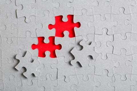 Grey jigsaw puzzle texture with missing pieces Stock Photos