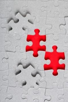 Grey jigsaw puzzle texture with missing pieces Stock Photos