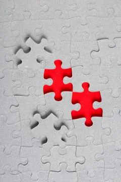 Grey jigsaw puzzle texture with missing pieces Stock Photos