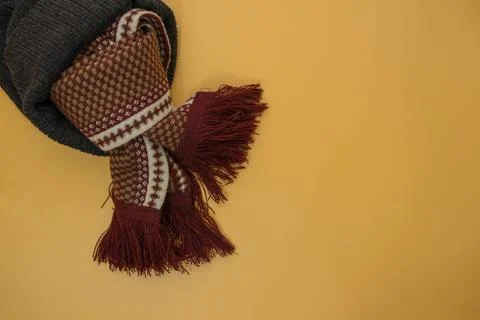 Grey knit hat and patterned scarf to protect against the cold. Stock Photos