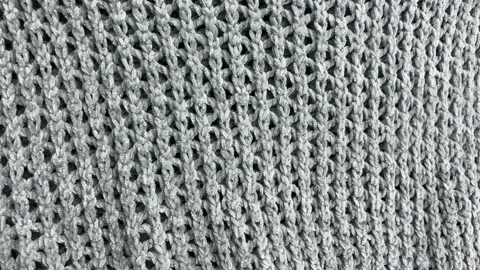 Grey knitted background. Grey knitted clothes Video stock 173390120