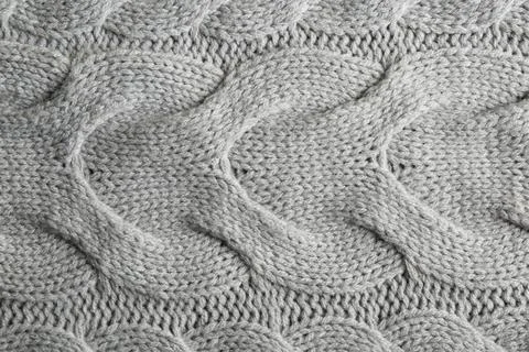 Grey knitted fabric with beautiful pattern as background, top view Stock Photos