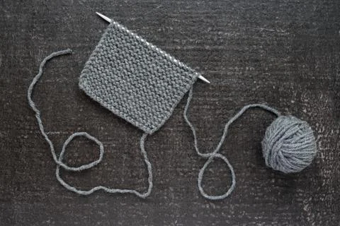 Grey knitting on black background Stock-Fotos