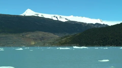 On Grey Lake Facing Sloping Mountains of Glaciers Stock Footage 100612696
