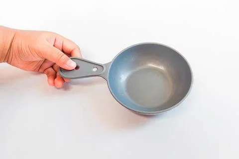 A grey melamine mini serving plate with an ergonomic handle is being held. Stock Photos