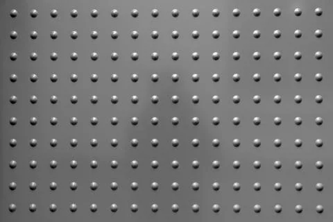 Grey metal background with spots in regular pattern Stock Photos