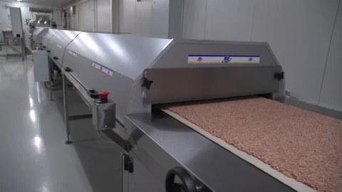 Grey metallic nut bar making machine with one worker in distance 動画素材 163713711
