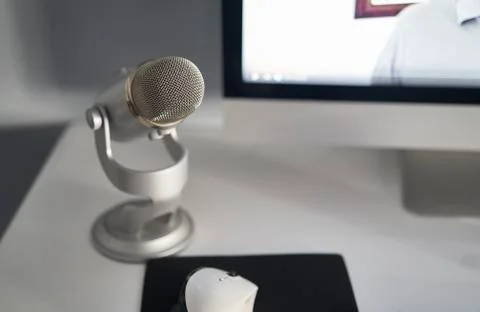 Grey microphone in a white table Stock Photos