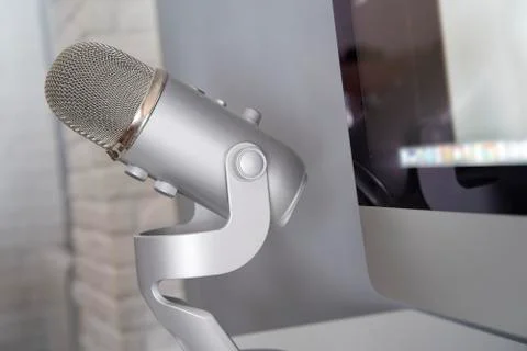 Grey microphone in a white table Stock Photos