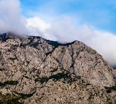 Grey mountain in clouds Stock Photos