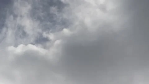 Grey moving clouds covering blue  close up Stock Footage 133911440