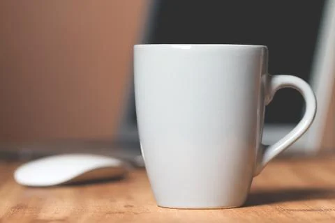 Grey mug on the desktop Stock Photos