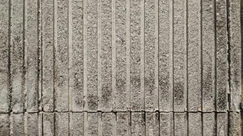 Grey natural stone texture background with vertical grooved lines. Stock Photos