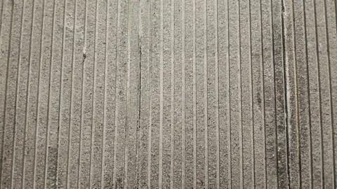 Grey natural stone texture background with vertical grooved lines. Stock Photos