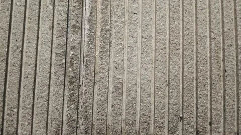 Grey natural stone texture background with vertical grooved lines. Stock Photos