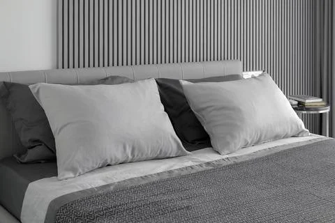 Grey pillows on the double bed in the bedroom Stock Photos