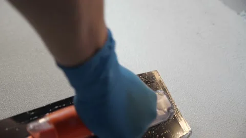 Grey plaster is generously applied to prepared surface. stains and texture Vídeos de archivo 157428831