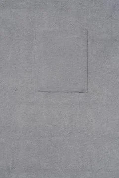 Grey plaster wall texture with rectangular repair patch 写真素材