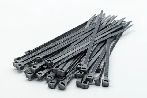 Grey plastic cable ties isolated on a white background Foto stock