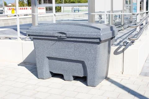 Grey Plastic Grit Bin for Winter Road Salt at Railway Station Stock Photos