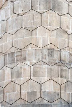  grey polygon hexagonal pattern on an old curved concrete block exterior w... Stock Photos