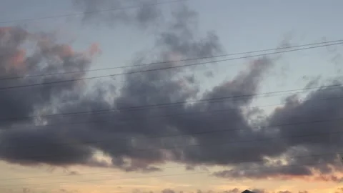 Grey rain clouds moving in summer sunset sky, warm evening cloudscape time lapse Stock Footage 163185514