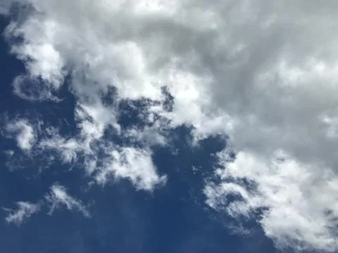 Grey raining storm cloudy and white clouds with dramatic bright blue sky Stock Photos