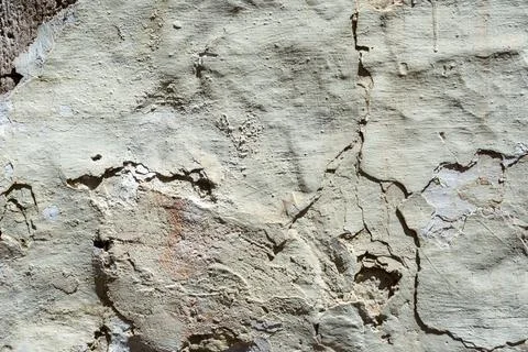 Grey rough cracked plaster wall abstract background. Stock Photos