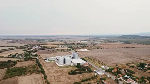 Grey Silos Wheat Bread Production Plant Slow Fly Over Rural Village in Bulgaria Stock Footage 237356310