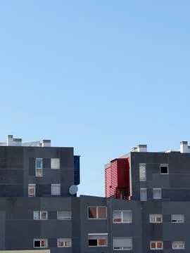 Grey simplistic lines of modern buildings against the clear sky. Modern arc.. Stock Photos