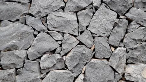 Grey stone background close-up. dark stone wall texture Stock Photos