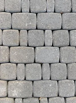 Grey stone blocks close up. Texture of brick wall, road or pavement Stock Photos