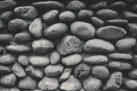 Grey stone siding with different size stones . Foto stock