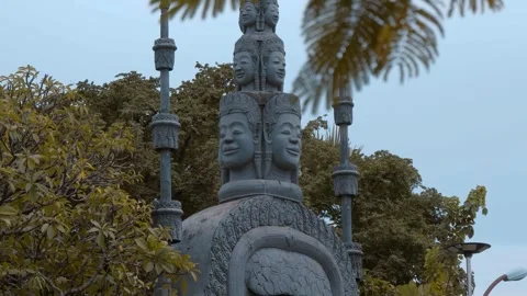 A grey stone statue of a Buddha with many heads facing all directions Stock Footage 318697938