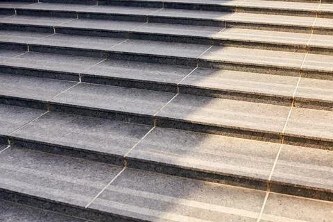 Grey stone steps in modern style, large staircase with stone-like grey textur Stock Photos