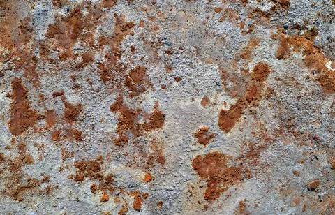 Grey stone texture with spots of rust. Abandoned industrial background Foto stock
