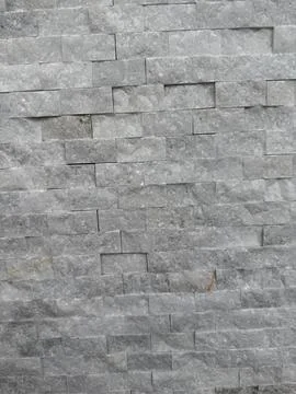 Grey stone tile wall pattern with textured surface, suitable as modern arch.. Foto stock