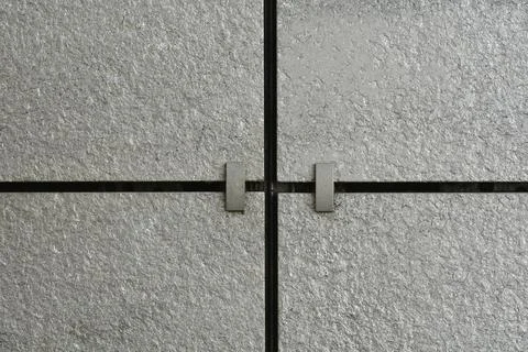 Grey stone tiles texture background with metal anchor clips Stock Photos