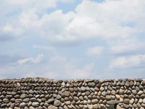 Grey stone wall and sky background Stock Photos