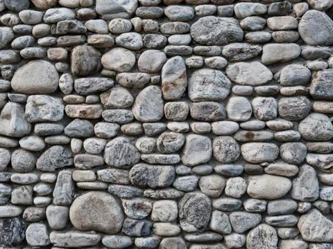 Grey stone wall as a background texture Stock Photos