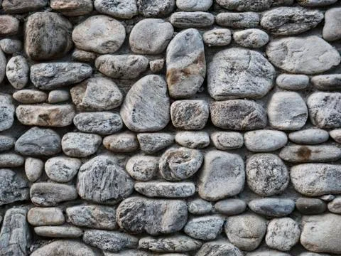 Grey stone wall as a background texture Stock Photos